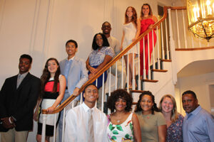 A group of people smiling while taking pictures